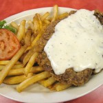 Sandersons Chicken Fried Steak - Lightly battered choice center cut sirloin smothered in country gravy, served with french fries.